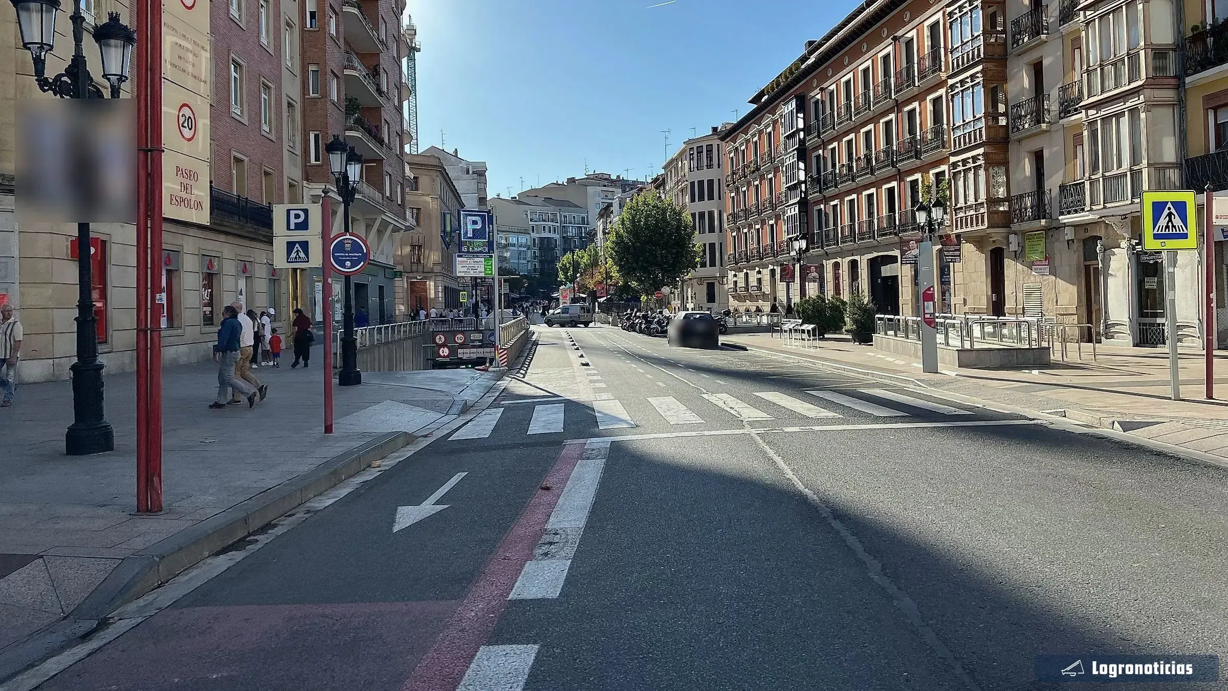 Calle junto al Paseo del Espolón con señal de parking y rampa de acceso subterráneo