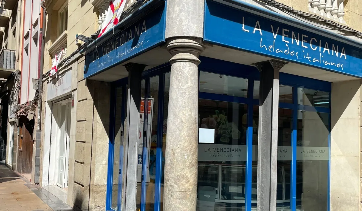 Esquina con soportales y rótulo azul de la heladería La Veneciana